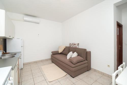 a living room with a couch in a kitchen at Apartments Ivica in Primošten