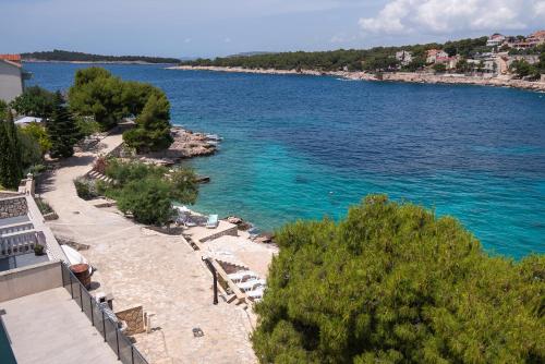 a view of a beach with the blue water at Apartments Ivica in Primošten