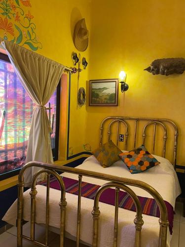 a bedroom with a bed with a canopy and a window at Ekléctic Hotel Boutique in Guadalajara
