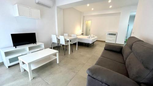 a living room with a couch and a table at Apartamentos Pintor Losada in Córdoba