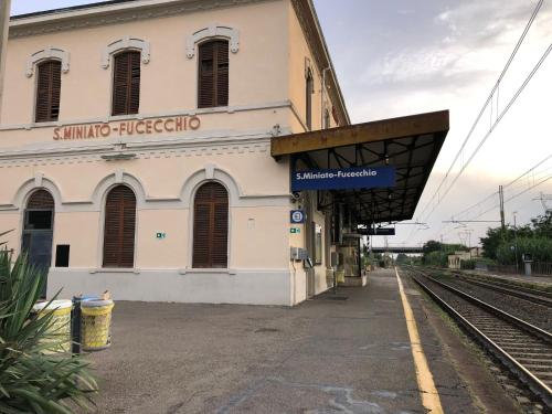 a building with a train station next to a train track at Appartamento VialeMarconi139, San Miniato in San Miniato Basso