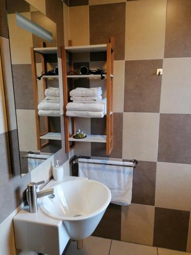 a bathroom with a sink and a mirror and towels at Casa rural SOROA landetxea in Arantza