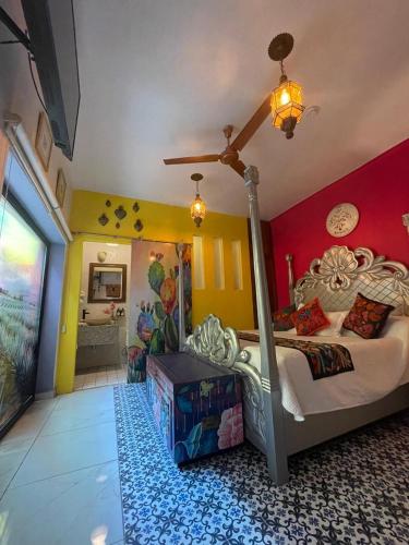 a bedroom with a large bed with a ceiling at Ekléctic Hotel Boutique in Guadalajara