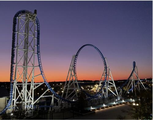 a roller coaster in a park at night at Park Avenue Beauty in Foley