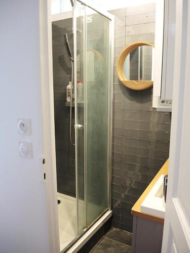 une douche avec une porte vitrée dans une salle de bain dans l'établissement Private Room with Bathroom in Sunny Flat, à Paris