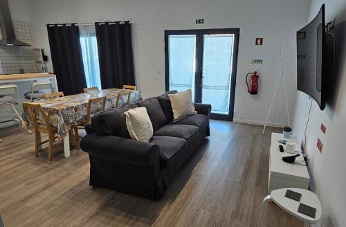 a living room with a couch and a table at Refúgio da Ilha in Ponta Delgada