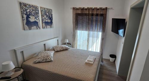 Ένα ή περισσότερα κρεβάτια σε δωμάτιο στο Refúgio da Ilha
