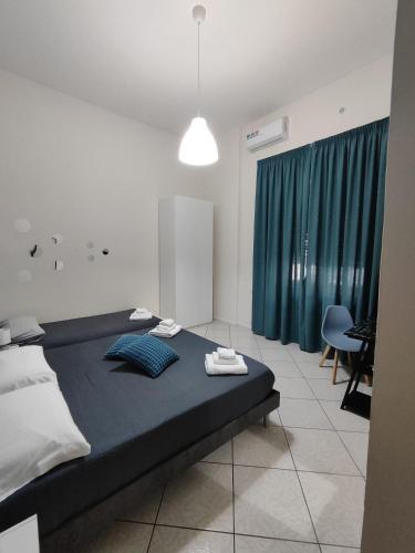 a bedroom with a large bed with a blue blanket at Nalusa Home in Sarno