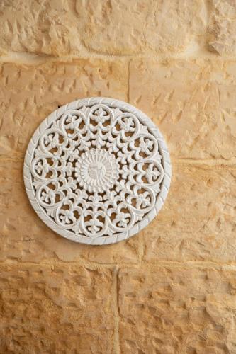 a white plate is on a wall at Blue Hues Katerina - House of Character in Qormi