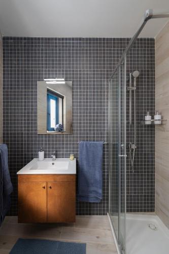 a bathroom with a sink and a shower at Blue Hues Katerina - House of Character in Qormi