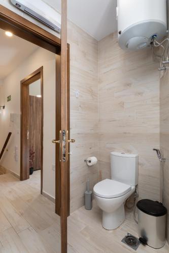 a bathroom with a toilet in a room at Blue Hues Katerina - House of Character in Qormi