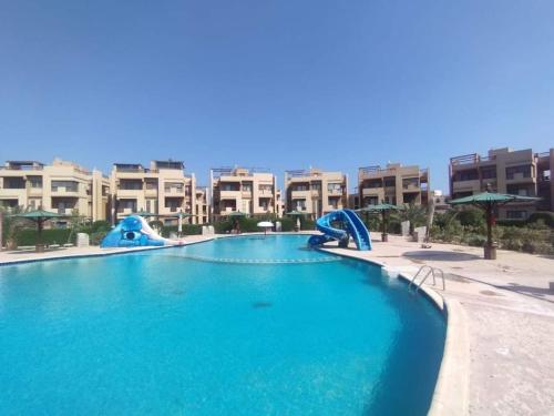 a large swimming pool in a resort with apartments at Elsokhna BlueBay Asia For families only in Ain Sokhna