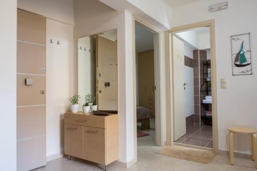 a dressing room with a mirror and a wooden dresser at Filora Apartment in the city center in Heraklio Town