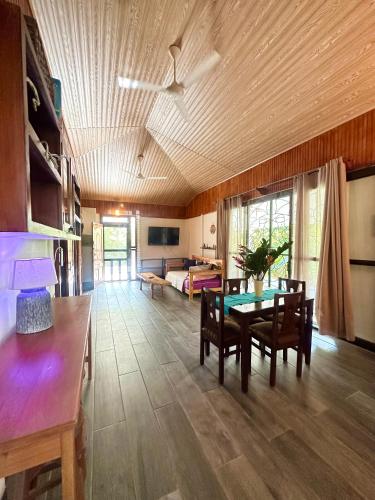 a living room with a table and a couch at Casa Del Bambu in Puerto Jiménez