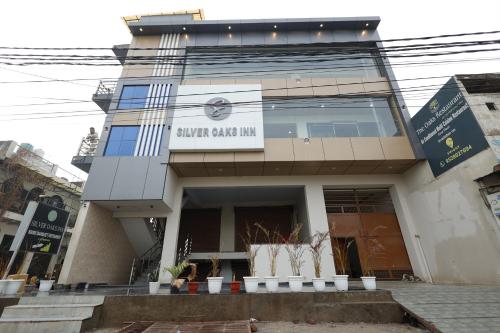 a building with a sign that reads ginger ball inn at Silver Oaks Inn in Mathura