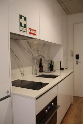 a kitchen with a sink and a counter top at Bemyguest - Loft Guest House Jardim das Mães Charming in Viseu