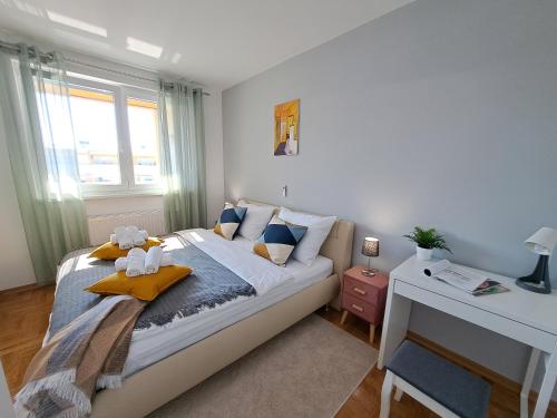 a bedroom with a bed with a teddy bear on it at Apartment CityAna - private garage, 0-24 Self Check In in Zagreb