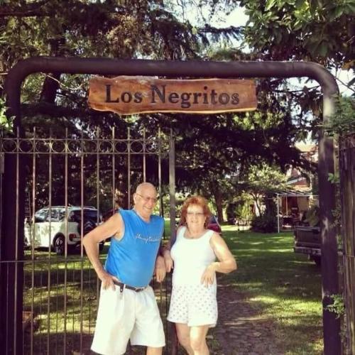 a man and a woman standing in front of a gate at Maravillosa Casa Quinta in Del Viso