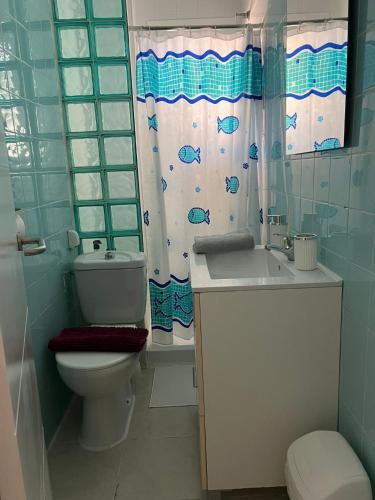 a bathroom with a toilet and a sink at Torrenostra Apartment in Grao de Castellón