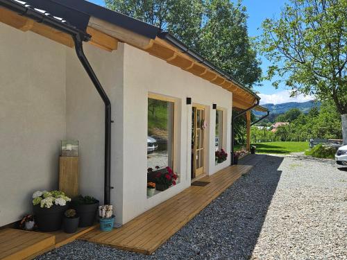 a house with a wooden deck with a view at Casa Mara Viseu de Sus in Vişeu de Sus