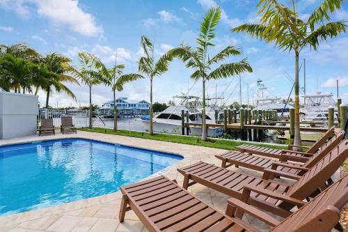a swimming pool with lounge chairs and a marina at Sailfish Suites - 11 - pet friendly in Stuart