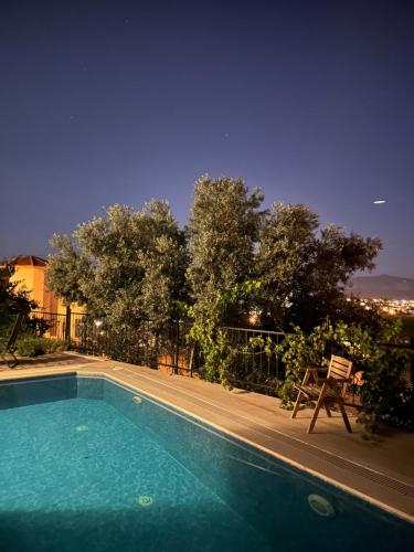a swimming pool at night with a view of a city at Oktapolis in Dalaman