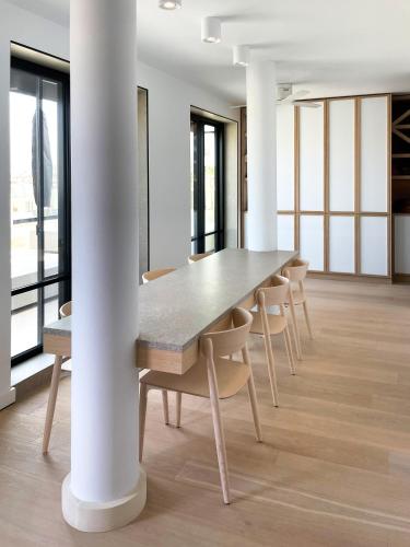 a table and chairs in a room with a column at Cité Privée - FORBIDDEN CITY Hotels in Kalkara