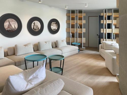 a living room with a couch and tables and mirrors at Cité Privée - FORBIDDEN CITY Hotels in Kalkara