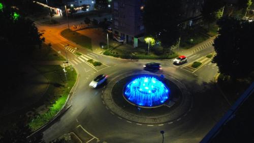 an intersection with cars in a city at night at Apartman Centar in Čapljina
