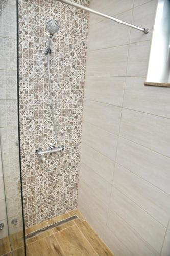a shower with a glass door in a bathroom at Apartman Centar in Čapljina