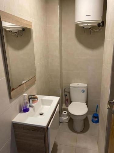 a small bathroom with a toilet and a sink at Appartement résidence -Sidi Rahal in Sidi Rahal