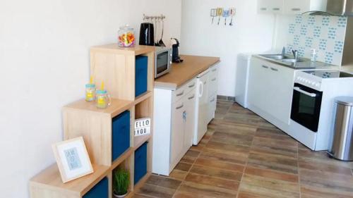une petite cuisine avec des armoires blanches et une cuisinière dans l'établissement Beau studio idéalement placé avec vue mer !, à Saint-Cyprien