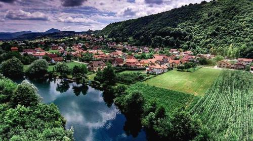 an aerial view of a village on a river at Hana Superior Apartments in Bihać