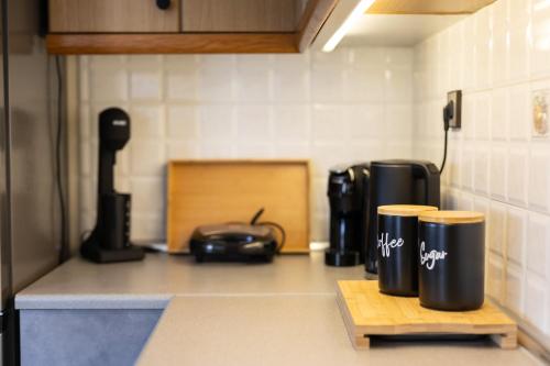 a kitchen counter with two coffee mugs on a counter at Villa Aelia Luxury Maisonette in Salamís