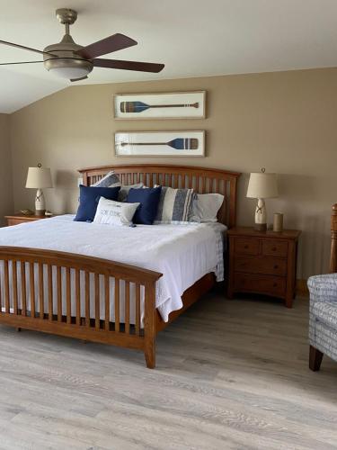 a bedroom with a large bed with blue pillows at Beach House - The Three Fish in Newport
