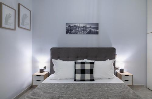 a bedroom with a large bed with two night stands at Villa Aelia Luxury Maisonette in Salamís