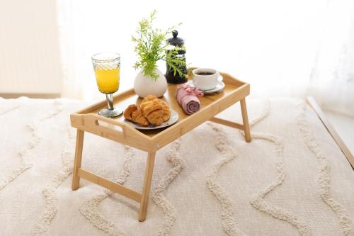 a table with a tray of food and a glass of orange juice at Villa Aelia Luxury Maisonette in Salamís