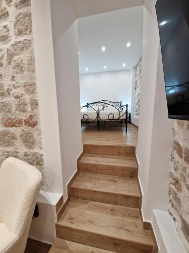 a staircase with a bed in the middle of a room at Small house Saint Michael in Šibenik