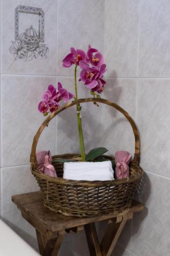 a basket with flowers on a table in a bathroom at Villa Aelia Luxury Maisonette in Salamís