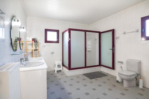 a bathroom with a toilet sink and a shower at Villa Aelia Luxury Maisonette in Salamís