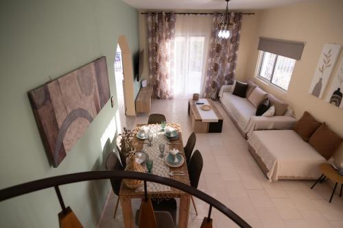 a living room with a table and a couch at Villa Aelia Luxury Maisonette in Salamís