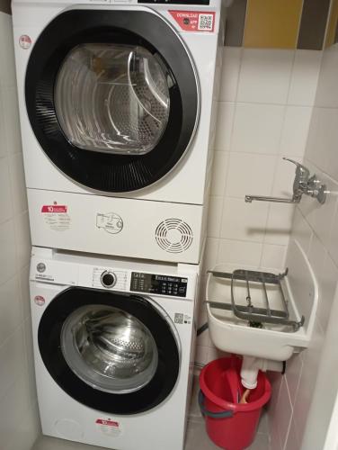 two washing machines and a sink in a bathroom at Soukromý apartmán Deluxe in Trutnov