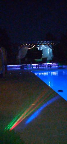 a swimming pool lit up at night with lights at Smestaj sa bazenom Sunny Hill in Smederevska Palanka