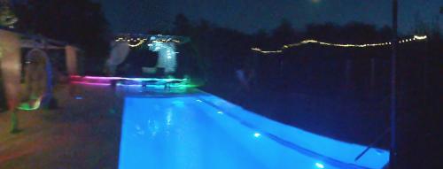 a swimming pool at night with blue lights at Smestaj sa bazenom Sunny Hill in Smederevska Palanka