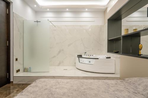 a bathroom with a shower and a white bath tub at Knez Imperium in Belgrade