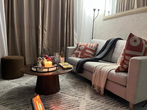 a living room with a couch and a table at Cozy retreat in Carlswald 264 in Midrand