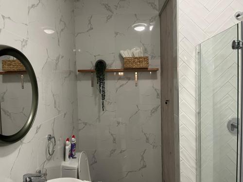 a bathroom with a shower and a sink and a mirror at Cozy retreat in Carlswald 264 in Midrand