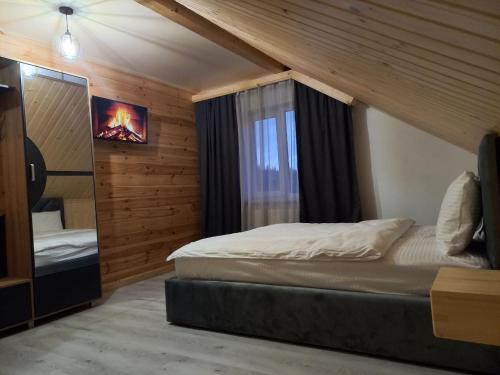 a bedroom with a bed and a window at Соломія in Slavske