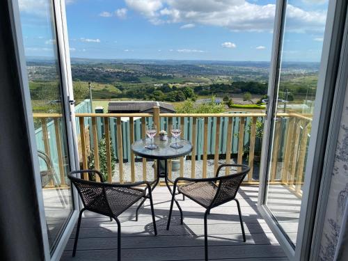 a table and chairs on a balcony with a view at Mountain View in Queensbury