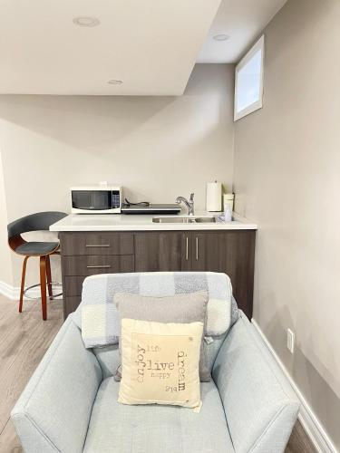 a living room with a couch with a pillow on it at Cozy 1.5 Guest-Suite in Aurora